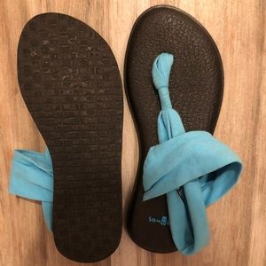 Blue Sanuk sandals.
